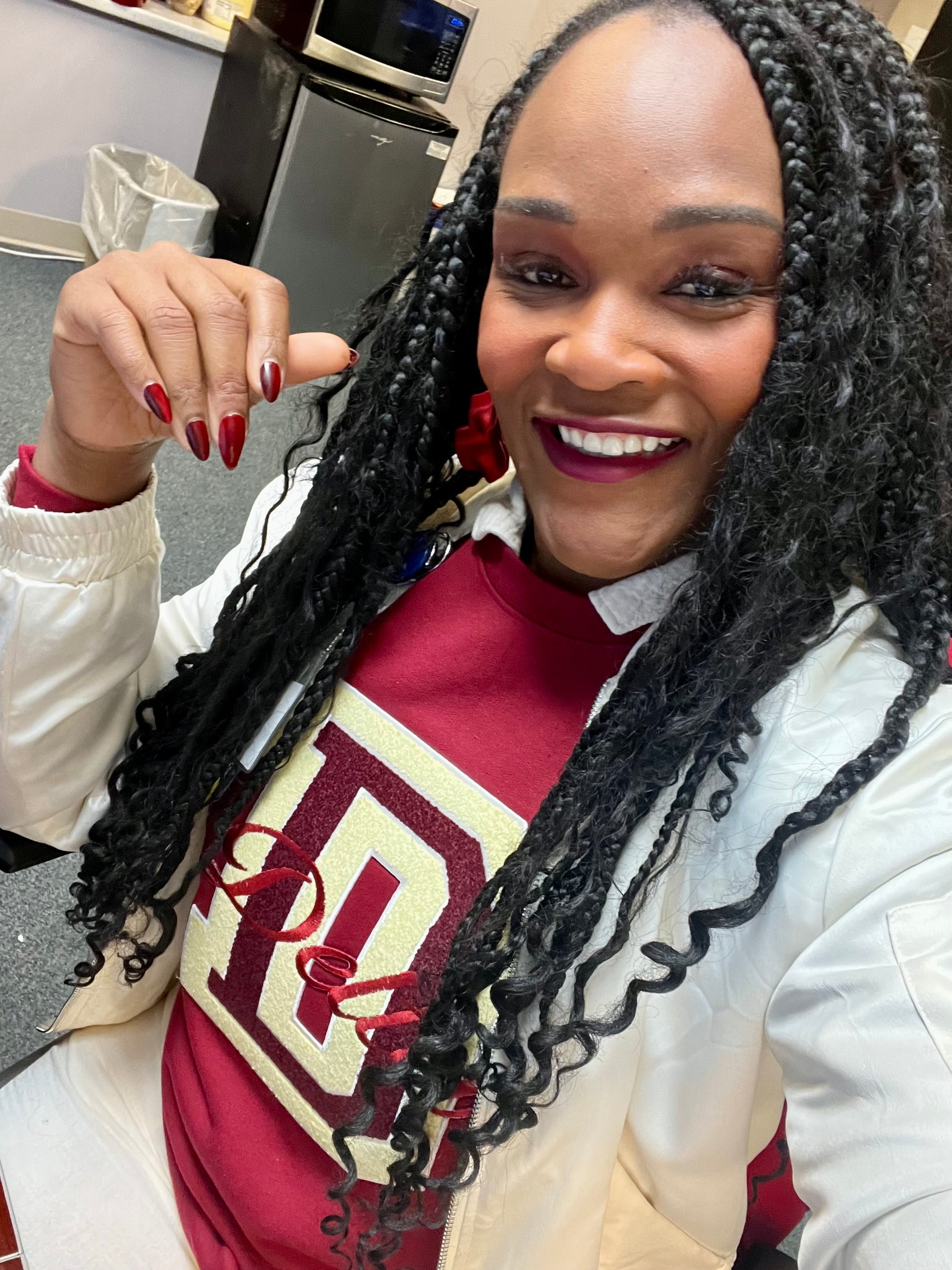 Close-up of chenille D patch and embroidered Delta script on crimson crewneck sweatshirt